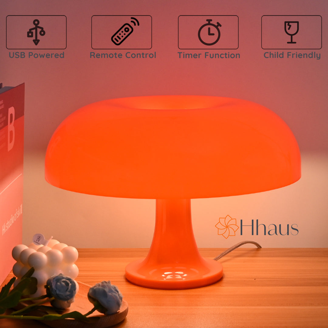 Orange coloured mushroom lamp next to books with features of lamp shown