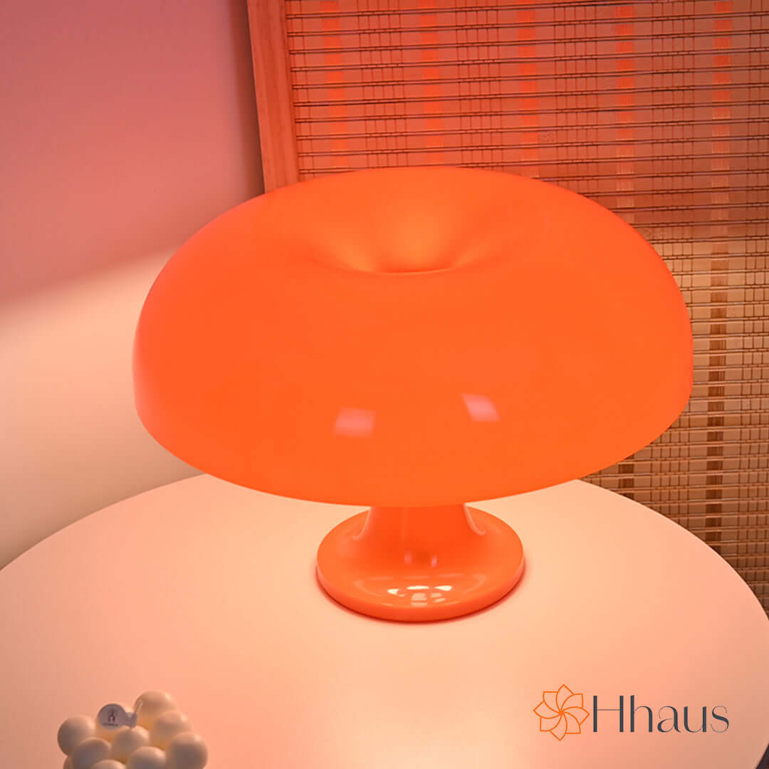 Orange coloured mushroom lamp shown from the table on coffee table