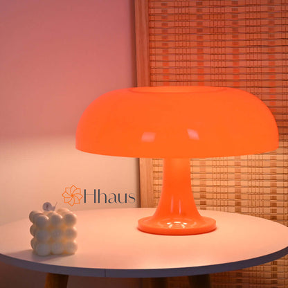 Orange coloured mushroom lamp on round coffee table